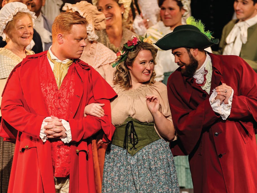 Kenneth Stavert as Belcore, Ashley Nuñez as Gianetta, and Eleomar Cuello as Dulcamara share a momentary love triangle in Vero Beach Opera’s 2024 production of L’Elisir d’Amore (photo by JPR Images)